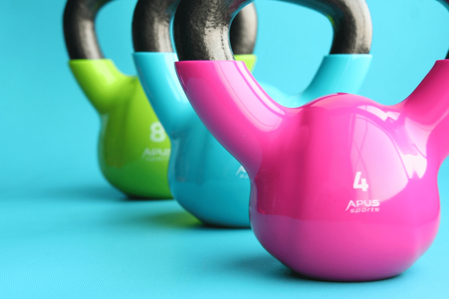 Colorful kettlebells on a blue surface