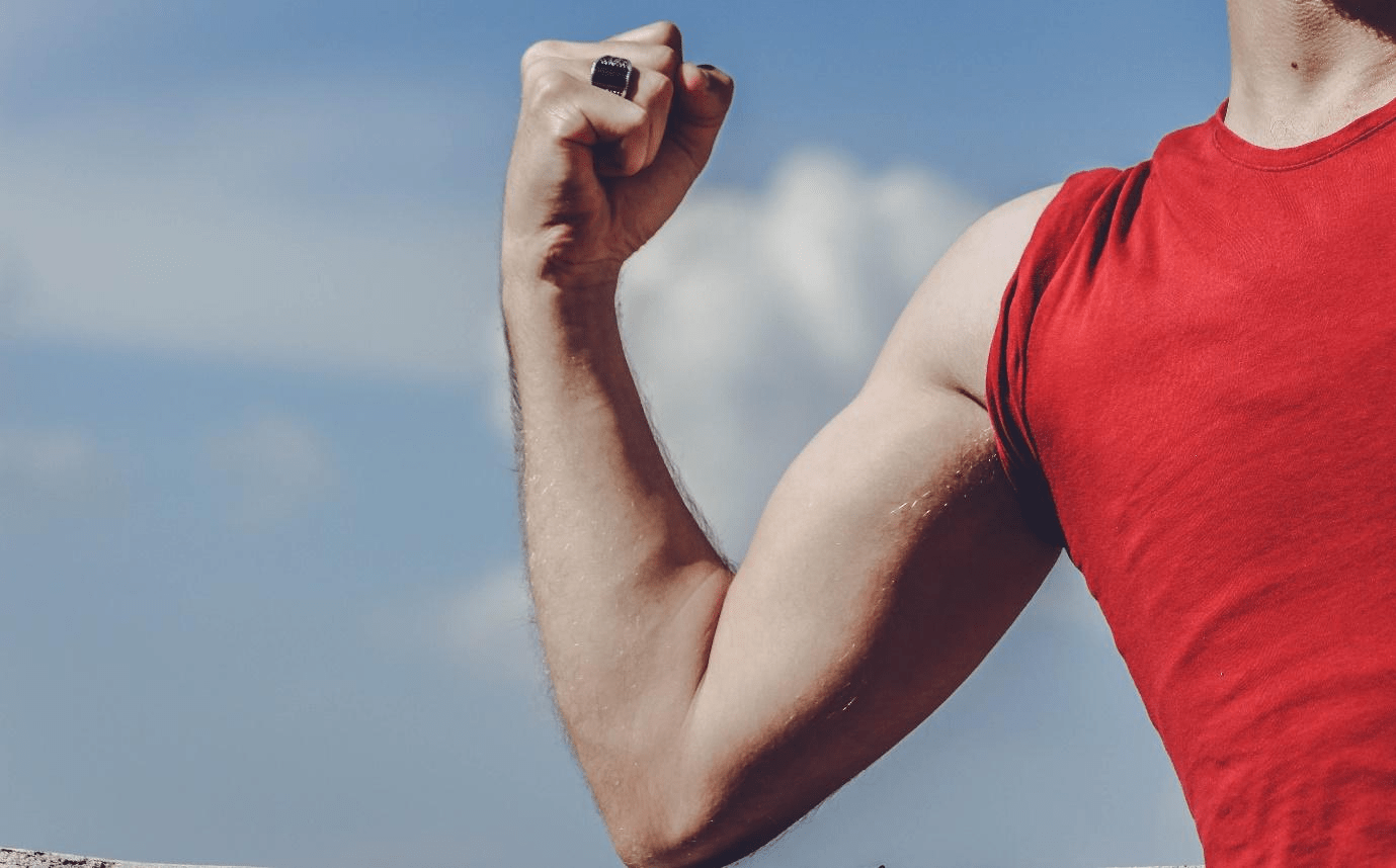 Person in red flexing a muscle