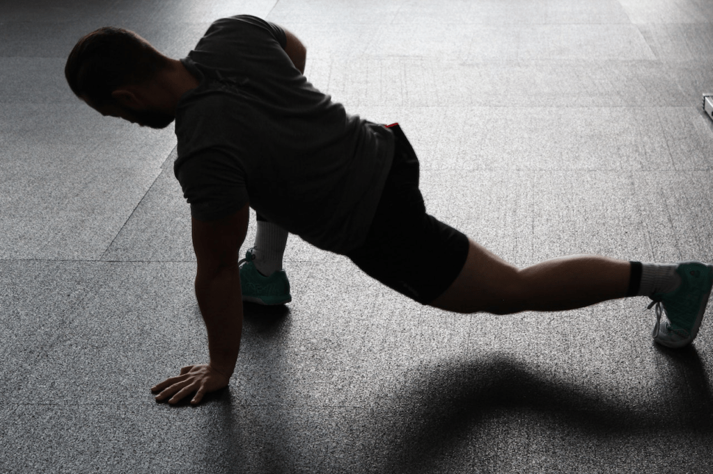  A man doing one-hand pushups